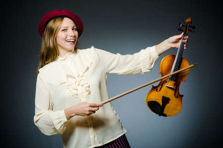 Woman violin player in musical conceptの写真素材