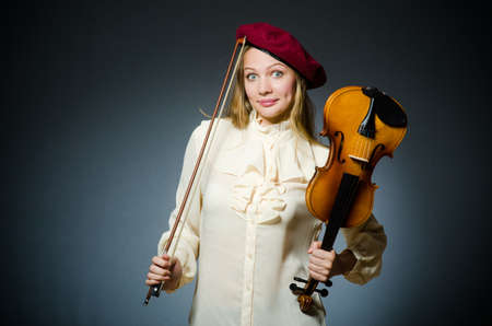 Woman violin player in musical conceptの写真素材