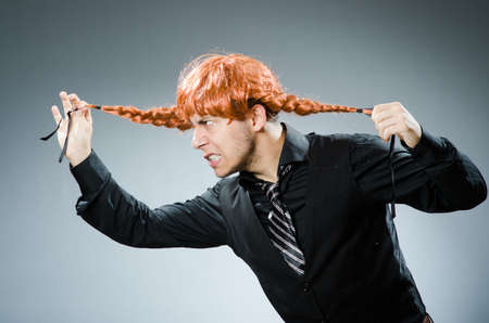 Funny man with red hair wigの写真素材