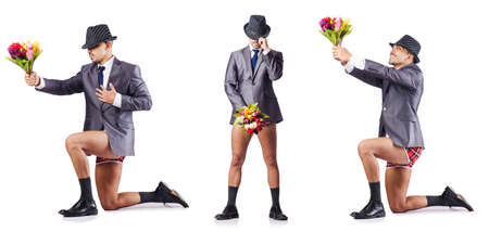 Nude businessman presenting flowers on whiteの写真素材