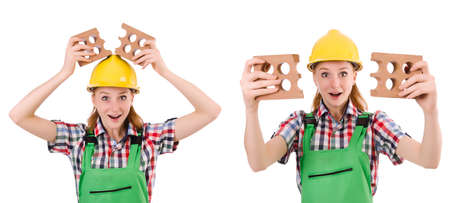 Woman with bricks isolated on whiteの写真素材