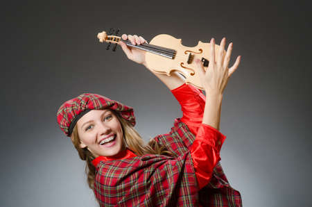 Woman in scottish clothing in musical conceptの写真素材