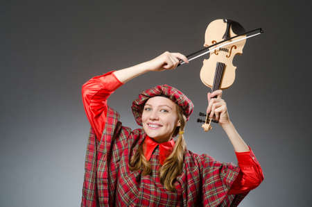 Woman in scottish clothing in musical conceptの写真素材