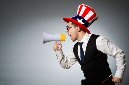 Man with loudspeaker wearing american hatの写真素材