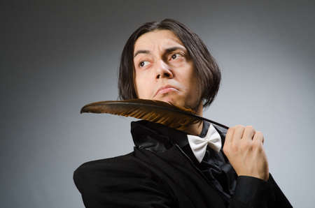 Young man with writing featherの写真素材