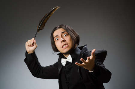 Young man with writing featherの写真素材