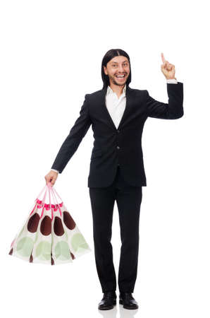 Black suit man holding plastic bags isolated on whiteの写真素材