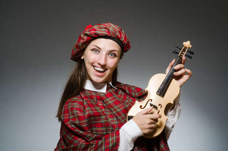 Woman in scottish clothing in musical conceptの写真素材