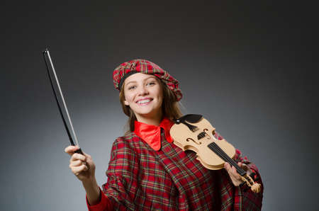 Woman in scottish clothing in musical conceptの写真素材