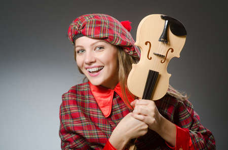 Woman in scottish clothing in musical conceptの写真素材