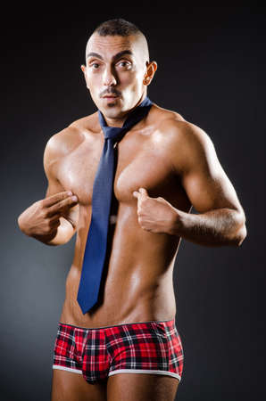 Ripped young man in studio conceptの写真素材