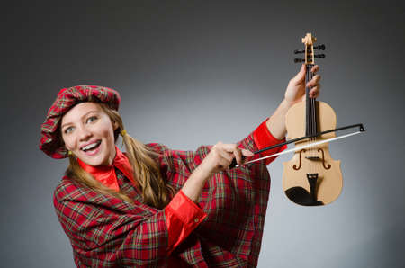 Woman in scottish clothing in musical conceptの写真素材