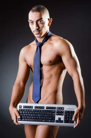 Ripped young man in studio conceptの写真素材