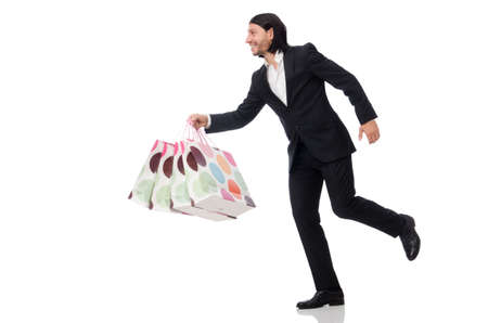 Black suit man holding plastic bags isolated on whiteの写真素材