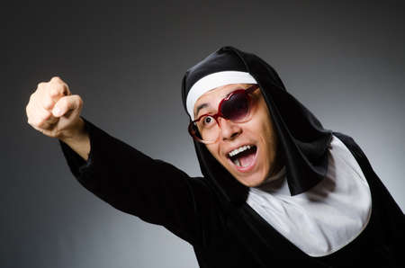 Man wearing nun clothing in funny conceptの写真素材
