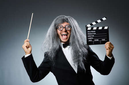 Funny man with movie clapboardの写真素材
