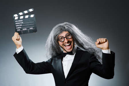 Funny man with movie clapboardの写真素材