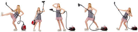 Young woman with vacuum cleaner on whiteの写真素材
