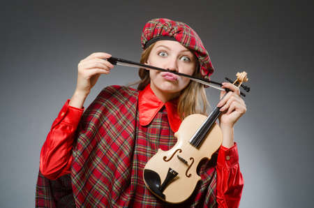 Woman in scottish clothing in musical conceptの写真素材