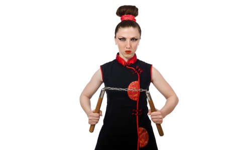 Funny woman with nunchucks isolated on whiteの写真素材