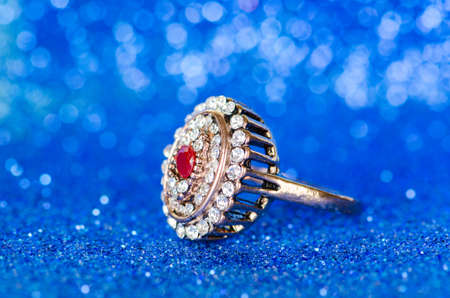 Jewellery ring against blue background