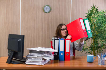 Businesswoman under stress working in the officeの写真素材