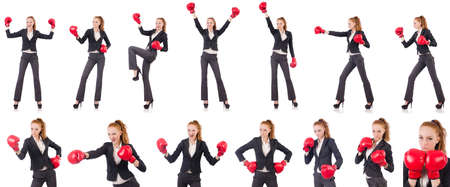 Woman businesswoman with boxing gloves on whiteの写真素材