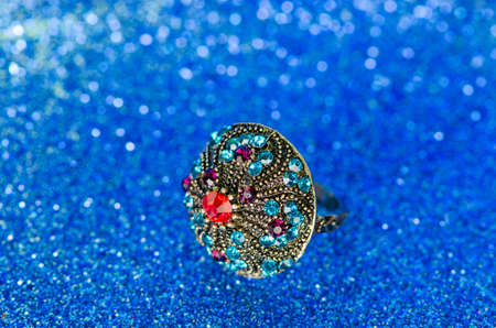Jewellery ring against blue background