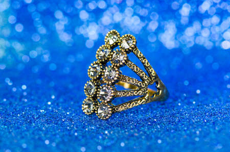Jewellery ring against blue background