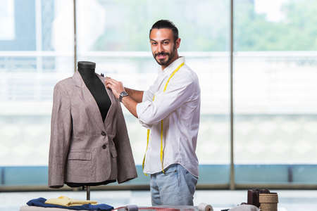 Young tailor working on new clothing design