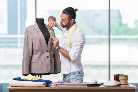 Young tailor working on new clothing designの写真素材