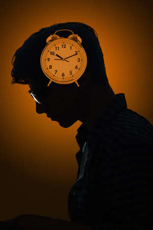 Concept of missing deadlines with man and clockの写真素材