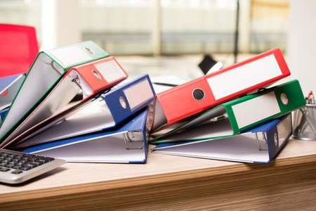 Stacks of office binders on deskの写真素材