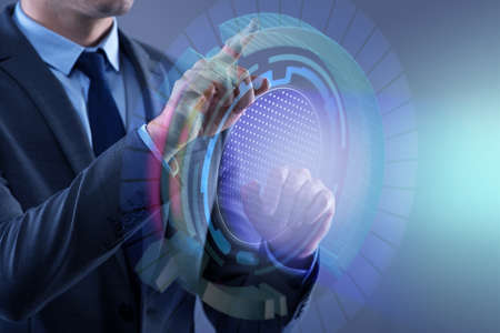 Businessman pressing virtual button in futuristic conceptの写真素材