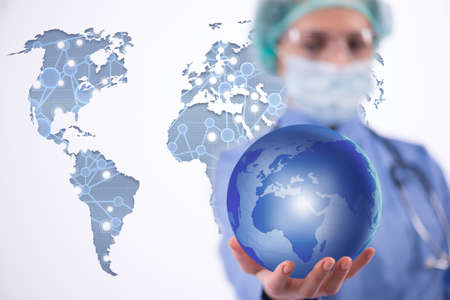 Woman doctor holding earth in globalisation conceptの写真素材