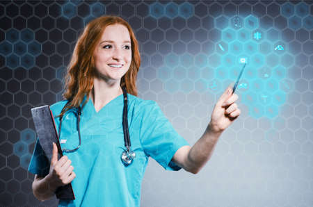 Young woman doctor pressing virtual buttonsの写真素材