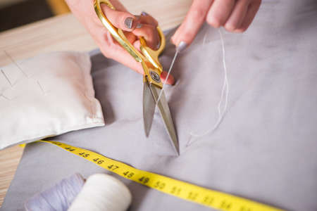 Tailor hands working on new clothing