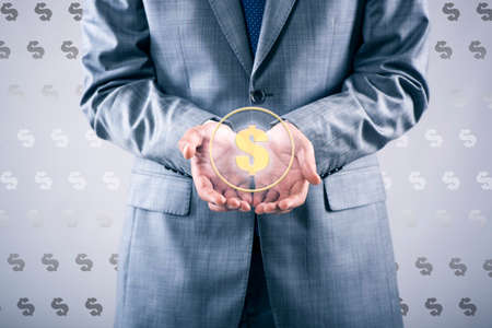 Man pressing dollar sign in finance conceptの写真素材