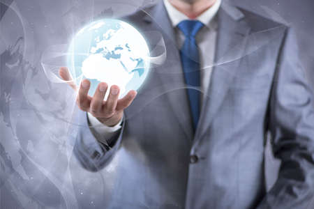 Businessman holding earth in global concept