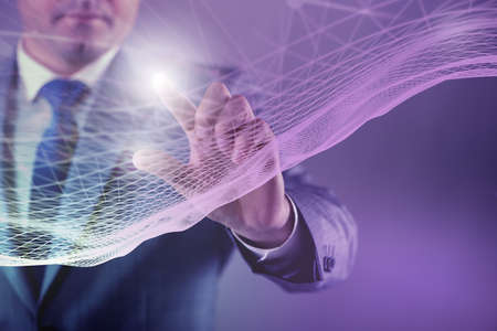Businessman pressing virtual button in futuristic conceptの写真素材