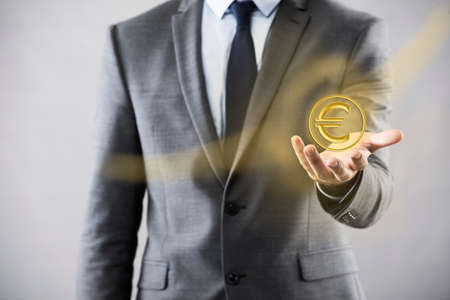 Man pressing buttons with euro currencyの写真素材