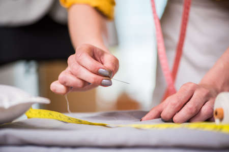 Tailor hands working on new clothing