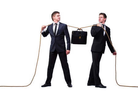 Twin brothers in tug of war concept isolated on whiteの写真素材