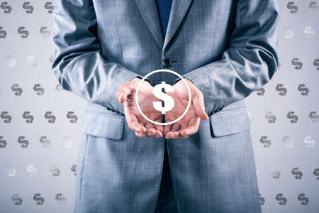 Man pressing dollar sign in finance conceptの写真素材
