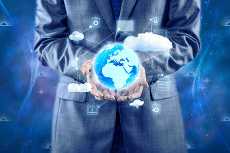 Businessman holding earth in global conceptの写真素材