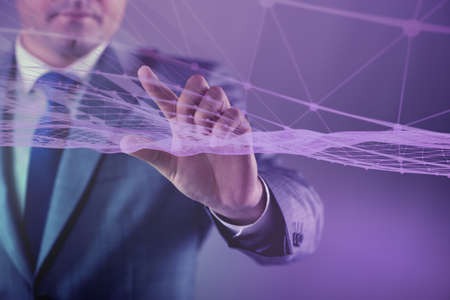 Businessman pressing virtual button in futuristic conceptの写真素材