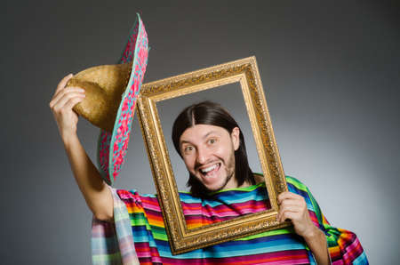 Funny man with sombrero and picture frameの写真素材