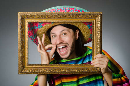 Funny man with sombrero and picture frameの写真素材