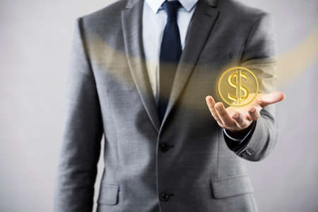Man pressing dollar sign in finance conceptの写真素材