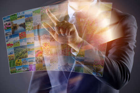 Man pressing buttons with nature photosの写真素材